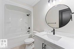 Full bath featuring shower / bath combination, vanity, and light tile patterned floors - 