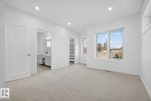 Unfurnished bedroom with light carpet, recessed lighting, a spacious closet, and ensuite bathroom - 14502 103 Avenue, Edmonton, AB - Indoor Photo Showing Other Room