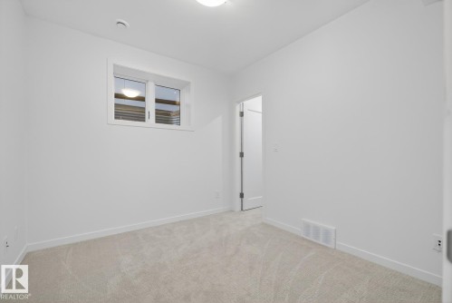 Basement bedroom with a large closet. - 14502 103 Avenue, Edmonton, AB - Indoor Photo Showing Other Room