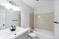 Bathroom featuring vanity and shower / bathtub combination - 