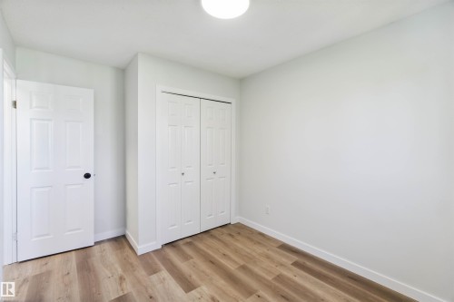 Unfurnished bedroom featuring light wood-type flooring and a closet - 1096 Millbourne Road E, Edmonton, AB - Indoor Photo Showing Other Room