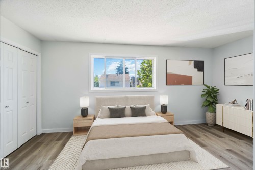Bedroom with a textured ceiling, wood finished floors, and a closet - 1096 Millbourne Road E, Edmonton, AB - Indoor Photo Showing Bedroom