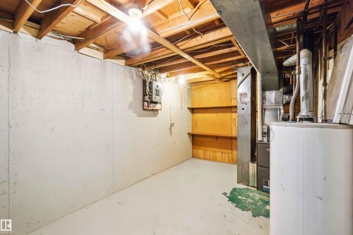 Unfinished below grade area with water heater and heating unit - 1096 Millbourne Road E, Edmonton, AB - Indoor Photo Showing Basement