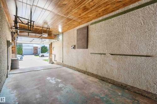 Garage featuring a textured wall and wooden ceiling - 1096 Millbourne Road E, Edmonton, AB - Indoor Photo Showing Garage