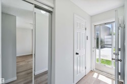 Entrance foyer featuring light wood-type flooring and a textured ceiling - 