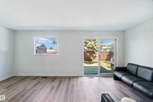 Living room with wood finished floors and baseboards - 1096 Millbourne Road E, Edmonton, AB - Indoor Photo Showing Living Room
