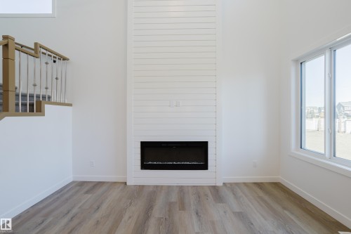 132 Mitchell Bend, Leduc, AB - Indoor Photo Showing Living Room With Fireplace