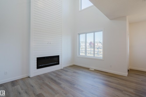 132 Mitchell Bend, Leduc, AB - Indoor Photo Showing Living Room With Fireplace