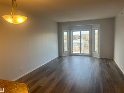 Empty room with dark wood-style floors and baseboards - 