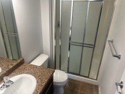 Full bathroom with vanity, a stall shower, and dark tile patterned flooring - 