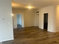 Empty room with dark wood-style flooring and a textured ceiling - 
