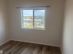 Unfurnished room with baseboards and dark wood-style floors - 
