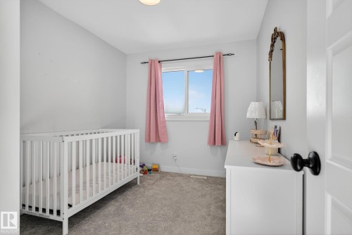 Bedroom featuring light carpet and a nursery area - 382 Crystallina Nera Drive, Edmonton, AB - Indoor Photo Showing Bedroom