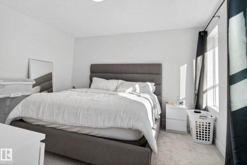 Carpeted bedroom featuring multiple windows - 382 Crystallina Nera Drive, Edmonton, AB - Indoor Photo Showing Bedroom