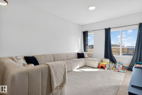 Living area featuring wood finished floors and recessed lighting - 382 Crystallina Nera Drive, Edmonton, AB - Indoor Photo Showing Living Room