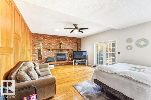 7550 Ellerslie Road, Edmonton, AB - Indoor Photo Showing Bedroom With Fireplace