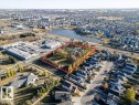 Aerial perspective of suburban area with property parcel outlined and a large body of water - 7550 Ellerslie Road, Edmonton, AB  - Outdoor With View 