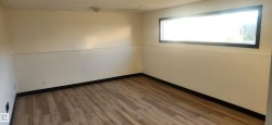 Empty room with hardwood / wood-style floors and a textured ceiling - 