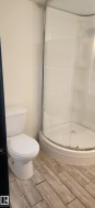 Full bathroom with wood tiled floors and a stall shower - 