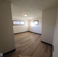 Empty room with light wood finished floors and baseboards - 