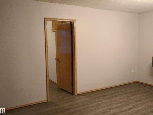 Unfurnished room featuring dark wood finished floors and baseboards - 4032A Twp Rd 604, Rural Barrhead County, AB - Indoor Photo Showing Other Room
