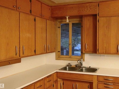 Kitchen with light countertops and brown cabinets - 4032A Twp Rd 604, Rural Barrhead County, AB - Indoor Photo Showing Kitchen With Double Sink