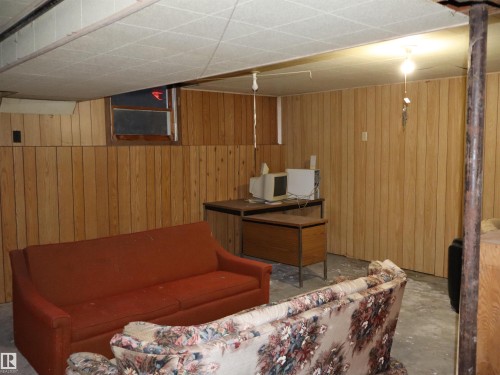 Living area with wooden walls and unfinished concrete floors - 4032A Twp Rd 604, Rural Barrhead County, AB - Indoor Photo Showing Other Room
