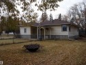 Rear view of house featuring an outdoor fire pit, a patio area, and a shingled roof - 4032A Twp Rd 604, Rural Barrhead County, AB  - Outdoor 