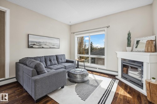 402 10524 77 Avenue, Edmonton, AB - Indoor Photo Showing Living Room With Fireplace