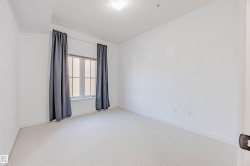 featuring light carpet and a textured ceiling - 