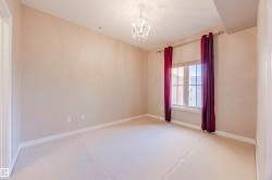 featuring a chandelier and light colored carpet - 
