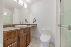 Full bathroom with vanity, light tile patterned flooring, and a stall shower - 