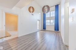 Spare room with a high ceiling and light wood finished floors - 