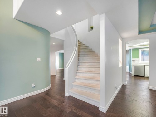 Staircase with arched walkways, wood finished floors, and recessed lighting - 316 Burton Road, Edmonton, AB - Indoor Photo Showing Other Room