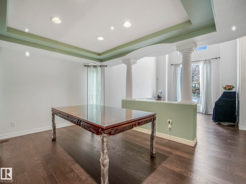Interior space featuring a raised ceiling, dark wood-style flooring, and recessed lighting - 316 Burton Road, Edmonton, AB - Indoor Photo Showing Other Room
