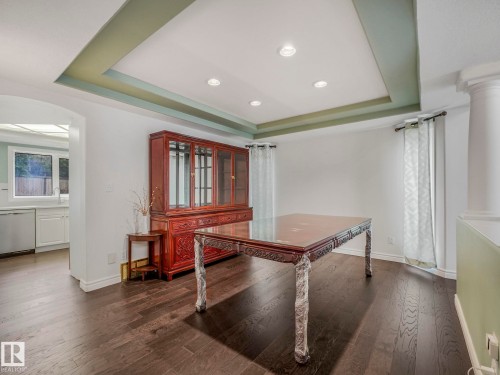 Office area with a tray ceiling, dark wood-style flooring, recessed lighting, and arched walkways - 316 Burton Road, Edmonton, AB - Indoor Photo Showing Other Room