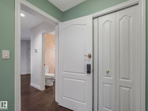 Hallway featuring dark wood-style flooring and a textured ceiling - 316 Burton Road, Edmonton, AB - Indoor Photo Showing Other Room