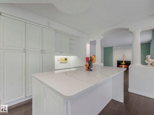 Kitchen with white cabinetry, dark wood-style floors, and open shelves - 316 Burton Road, Edmonton, AB - Indoor Photo Showing Kitchen
