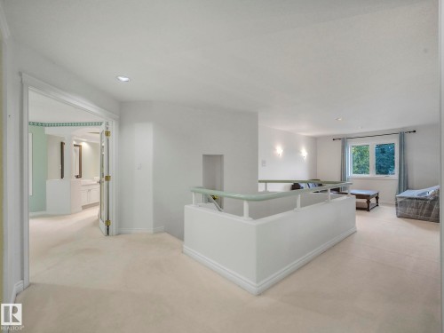 Hallway with light carpet, recessed lighting, and an upstairs landing - 316 Burton Road, Edmonton, AB - Indoor Photo Showing Other Room