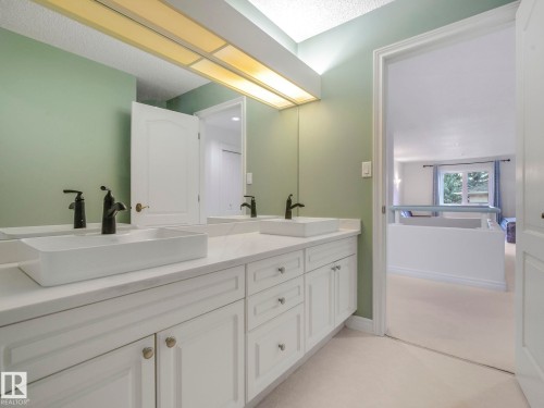 Bathroom featuring double vanity and a textured ceiling - 316 Burton Road, Edmonton, AB - Indoor Photo Showing Bathroom