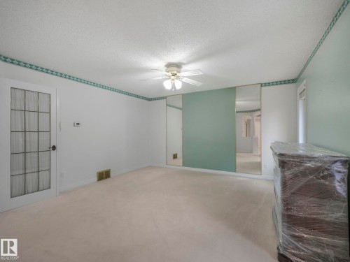 Empty room with carpet, a textured ceiling, and ceiling fan - 316 Burton Road, Edmonton, AB - Indoor Photo Showing Other Room