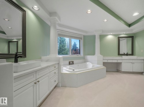 Full bath with recessed lighting, two vanities, a garden tub, light colored carpet, and a raised ceiling - 316 Burton Road, Edmonton, AB - Indoor Photo Showing Bathroom