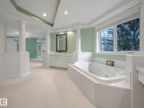 Bathroom with a whirlpool tub, recessed lighting, light carpet, vanity, and a tray ceiling - 316 Burton Road, Edmonton, AB - Indoor Photo Showing Bathroom