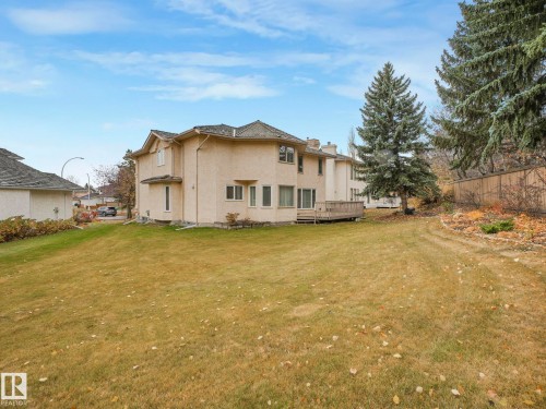 Back of house featuring a deck, stucco siding, and a chimney - 316 Burton Road, Edmonton, AB - Outdoor