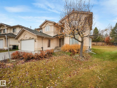 Traditional home with a front lawn, stucco siding, and a garage - 316 Burton Road, Edmonton, AB - Outdoor