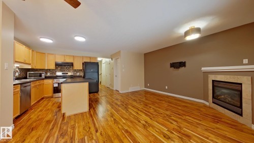1148 Barnes Way, Edmonton, AB - Indoor Photo Showing Kitchen With Fireplace