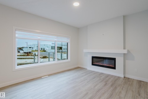 4201 66 Street, Beaumont, AB - Indoor Photo Showing Living Room With Fireplace