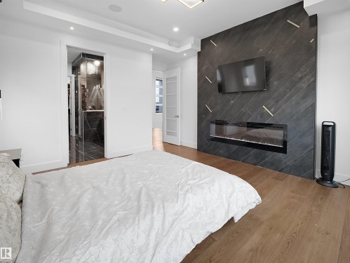 4809 Woolsey Lane, Edmonton, AB - Indoor Photo Showing Bedroom With Fireplace