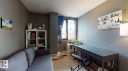 Home office with a textured ceiling and light carpet - 