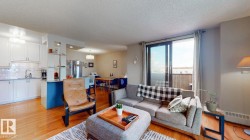 Living room featuring light wood-style floors and a textured ceiling - 